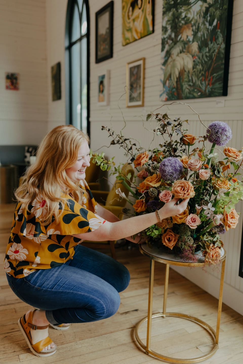 Mallory, owner and lead designer, arranging flowers in her Austin studio